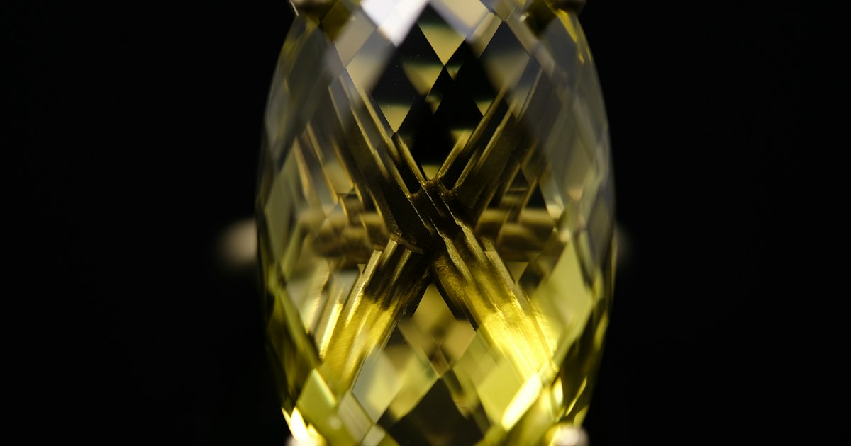 A faceted oval golden citrine gemstone set in a sterling silver ring